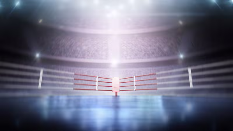 Boxing ring lit by overhead spotlights