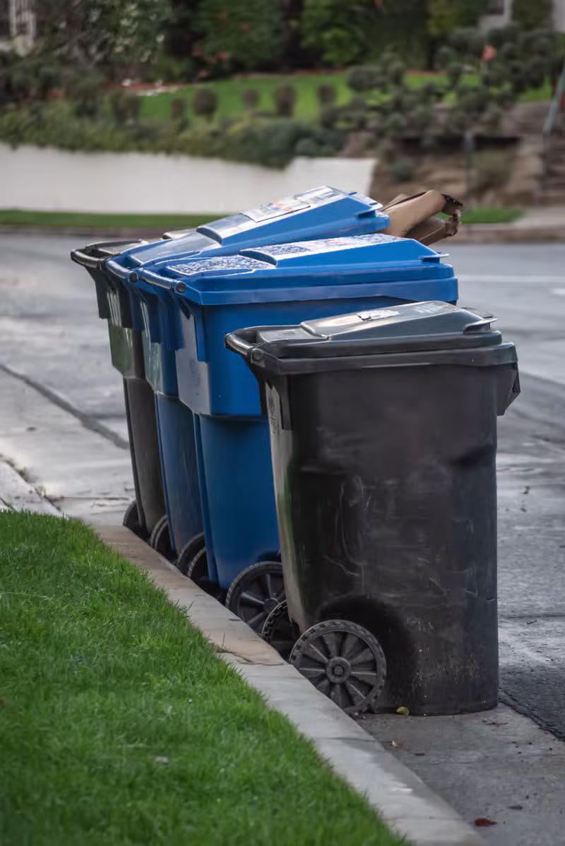Waste management collection truck on a clean city street