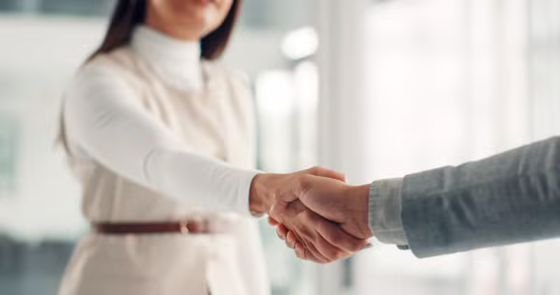 Professionals shaking hands in a corporate office