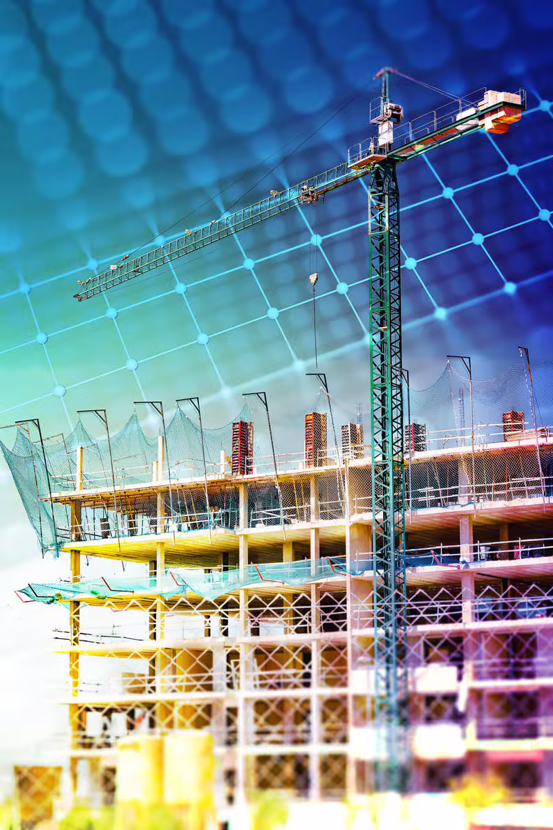 Șantier de construcții cu echipă și schele pe o clădire modernă