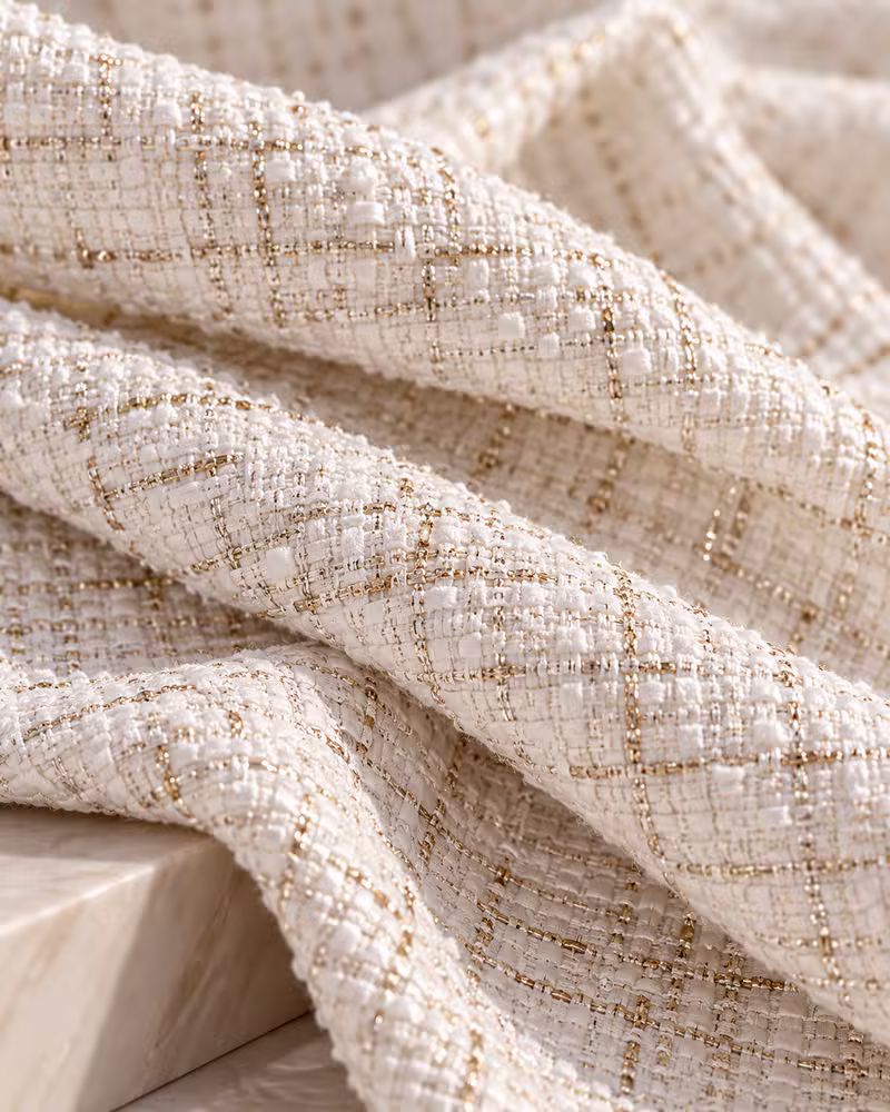 Ivory tweed woven with shimmering gold metallic thread