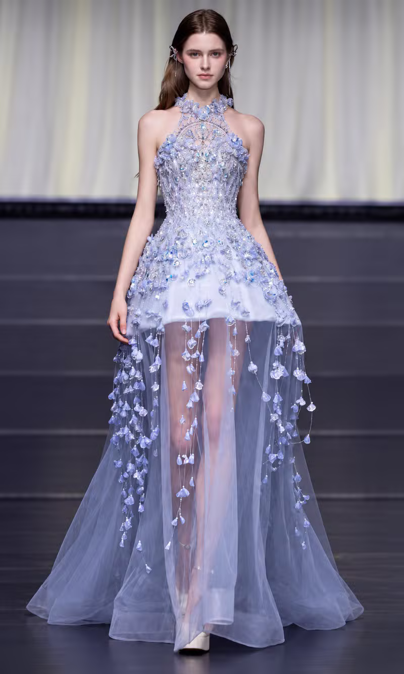 Ice blue crystal beaded couture gown with a sheer tulle skirt and trailing floral applique