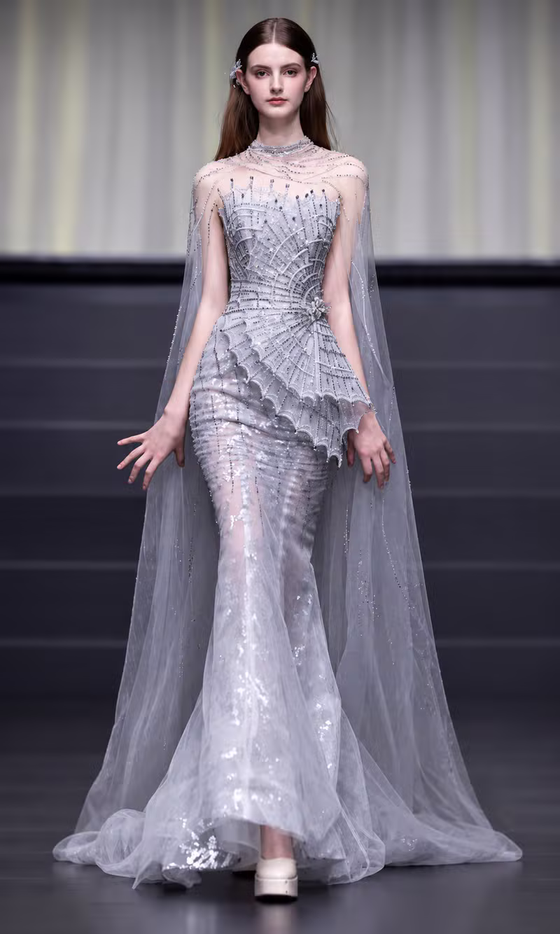 Silver web-pattern beaded couture gown with a sheer tulle cape