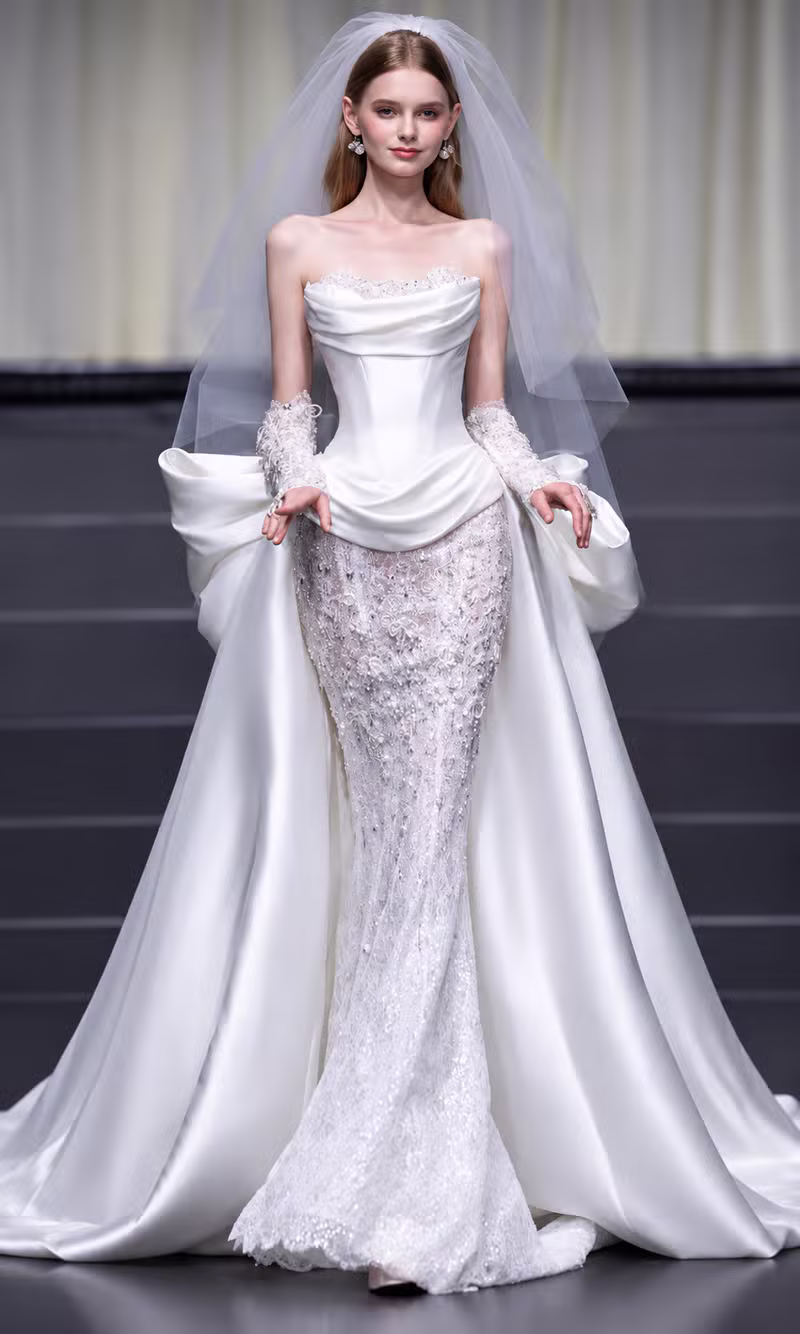 Ivory satin corset bridal gown with a lace mermaid skirt and tulle veil