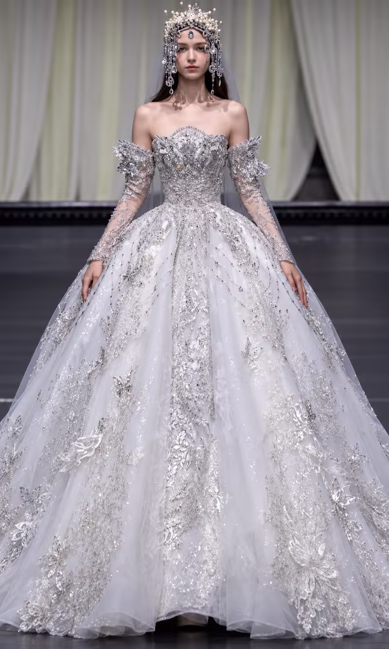 Silver beaded couture ball gown with an ornate crystal crown and full skirt