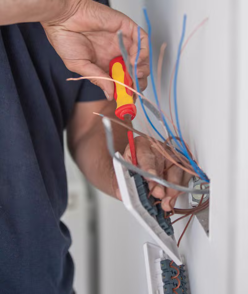 Qualified electrician testing a consumer unit in a Yorkshire home
