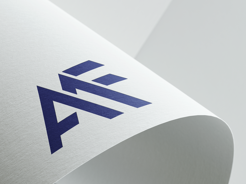 AMF monogram logo in indigo applied to a light paper surface