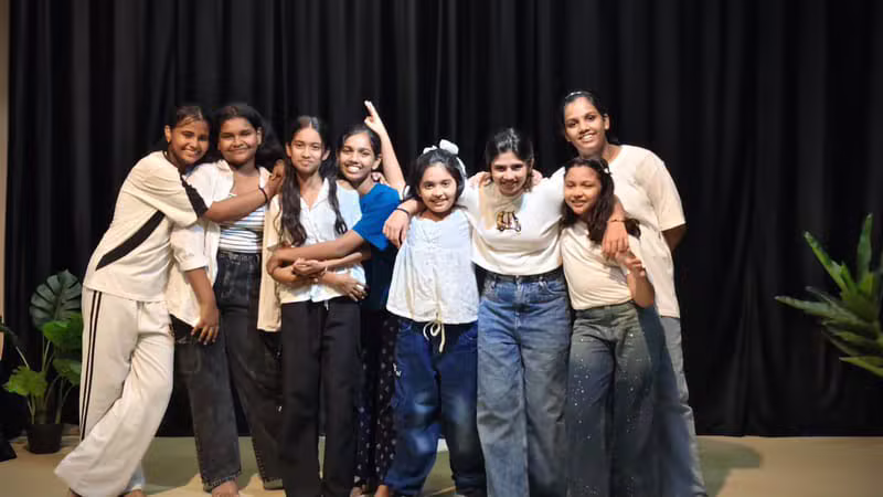 Young dancers posing together during a kids batch rehearsal