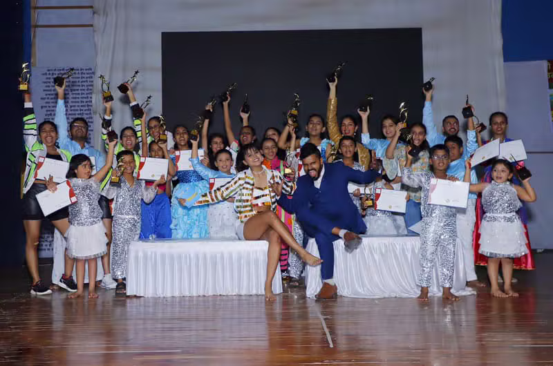 Winners celebrating with trophies at a dance competition