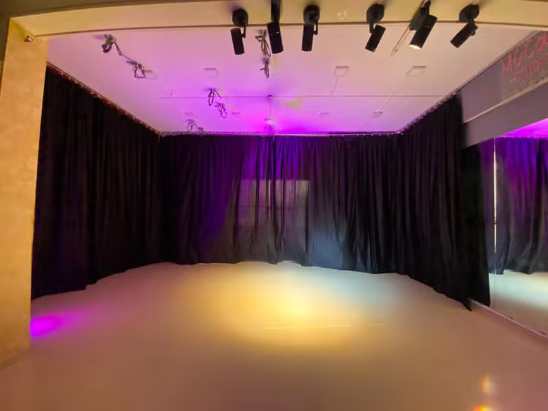 Studio floor washed in blue and gold stage lighting