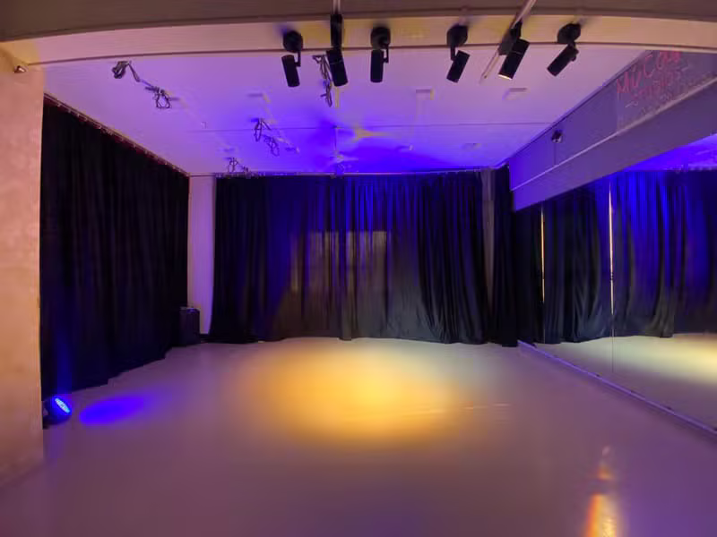 Dance studio bathed in magenta stage lighting
