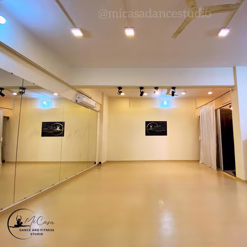 Wide view of the MiCasa studio floor with mirrors, fans and the studio logo