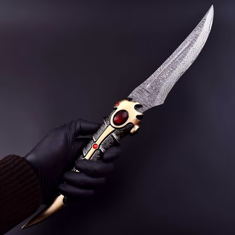 Hand holding a damascus dragon dagger from the A1 Swords & Knives workshop
