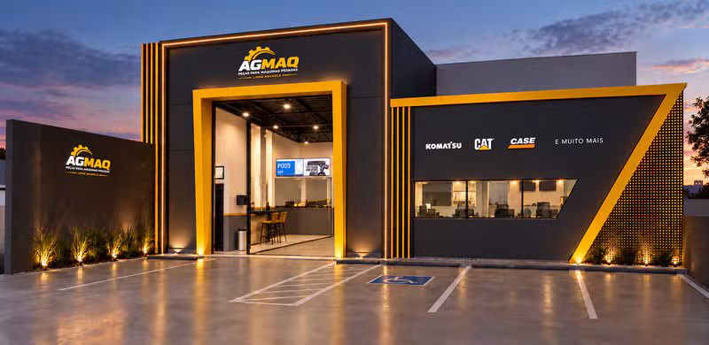 Fachada iluminada da loja Agmaq, especializada em peças para máquinas pesadas