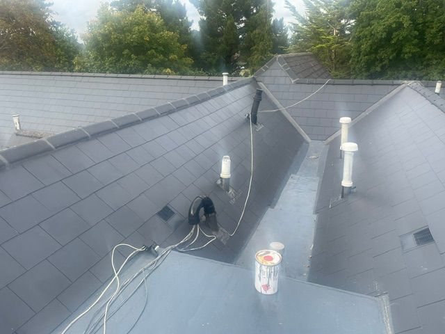 liquid waterproofing of large gulley area and new fibercement slates on surrounding roof slopes on block of flats