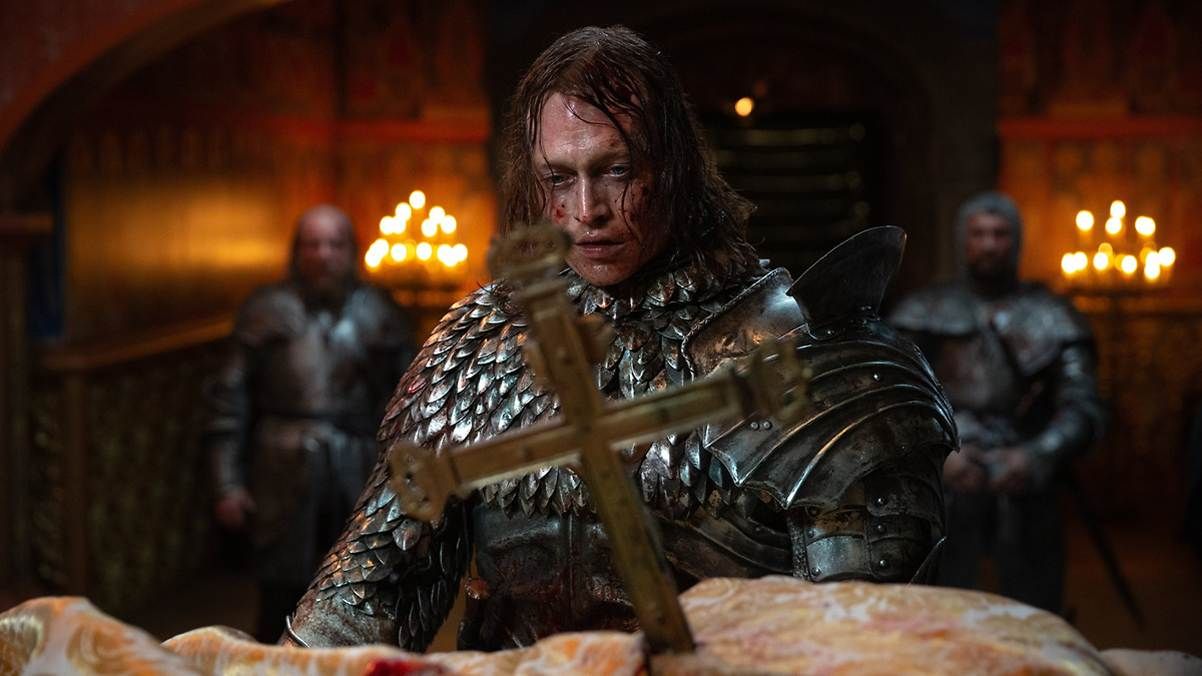 A person in armor holding a crossAI-generated content may be incorrect.