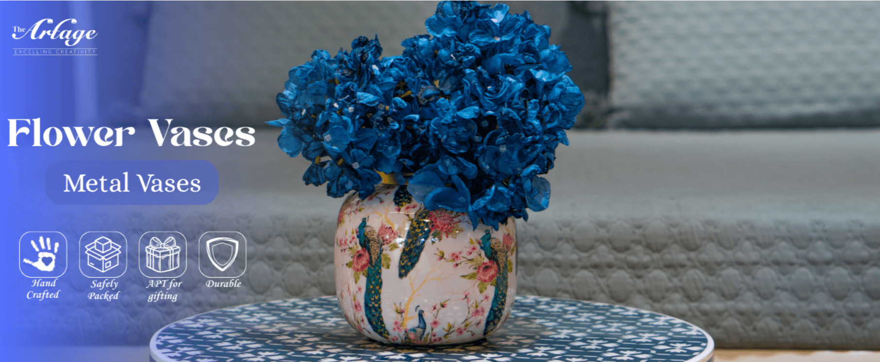 Vase with blue artificial flowers placed on table with patterned mat