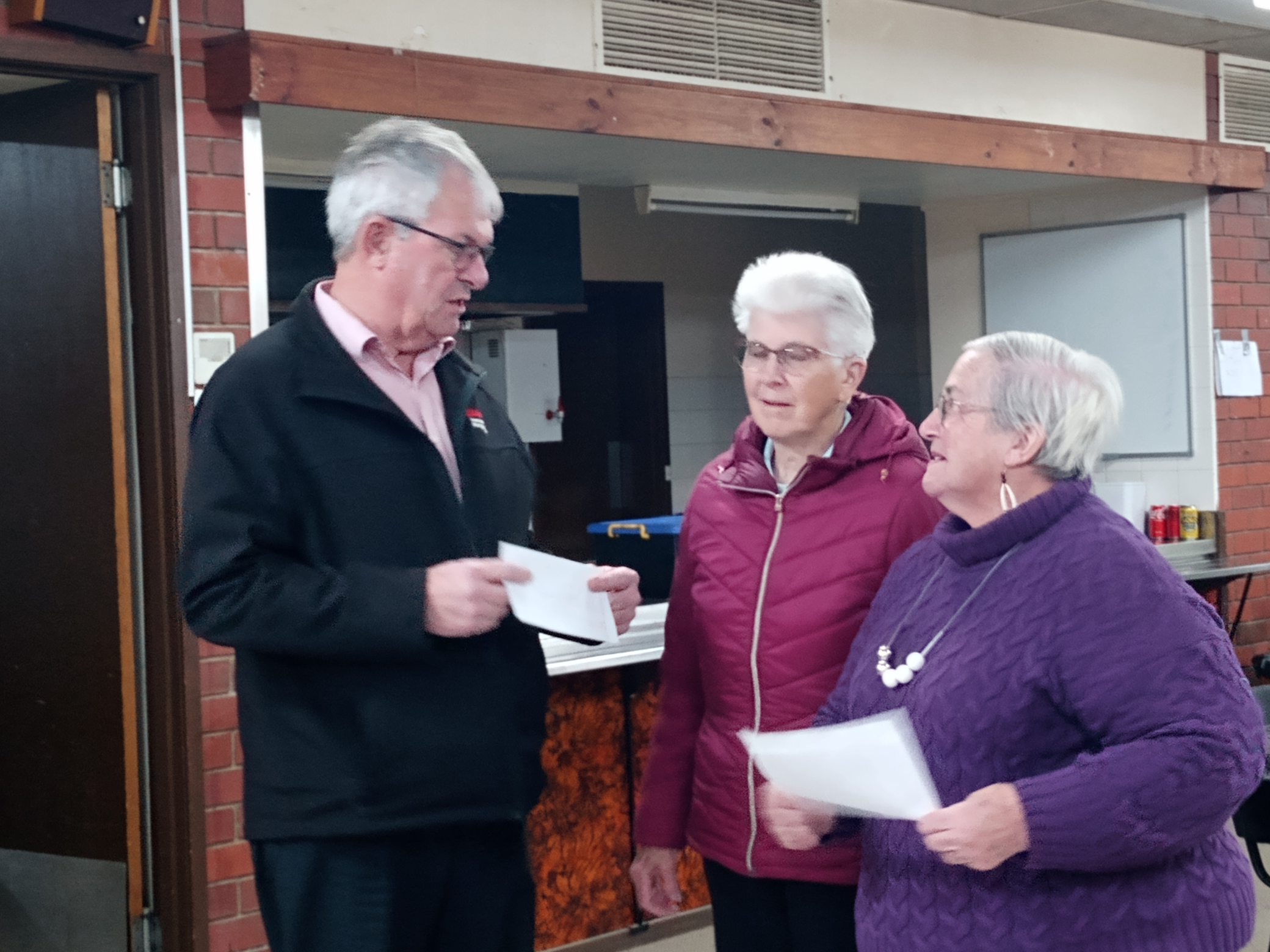 Lyn and Carol from the St Michaels Friendship and Craft Group presenting Carevan Wangaratta President John Houghton with a cheque for $1,000.