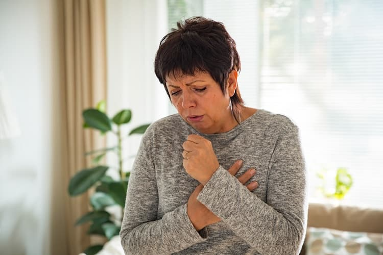 Photo of a woman coughing