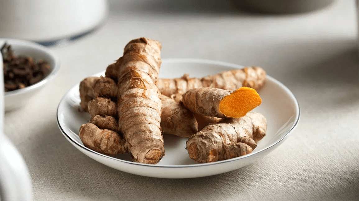 raw turmeric root on a plate