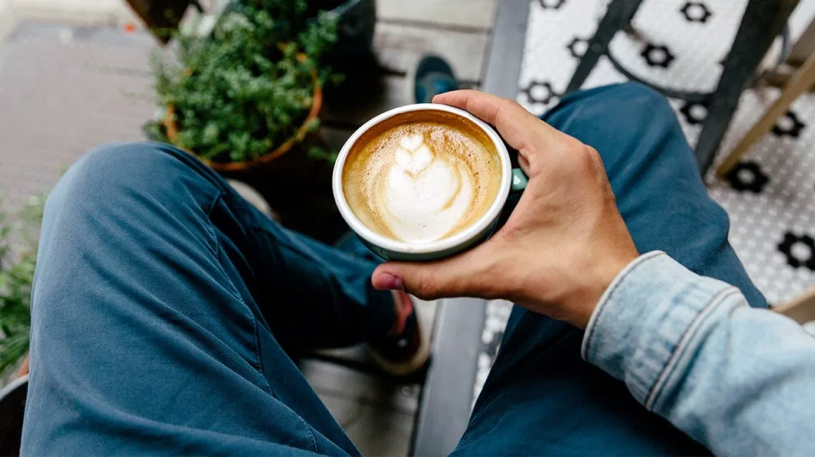 Man holding a coffee drink