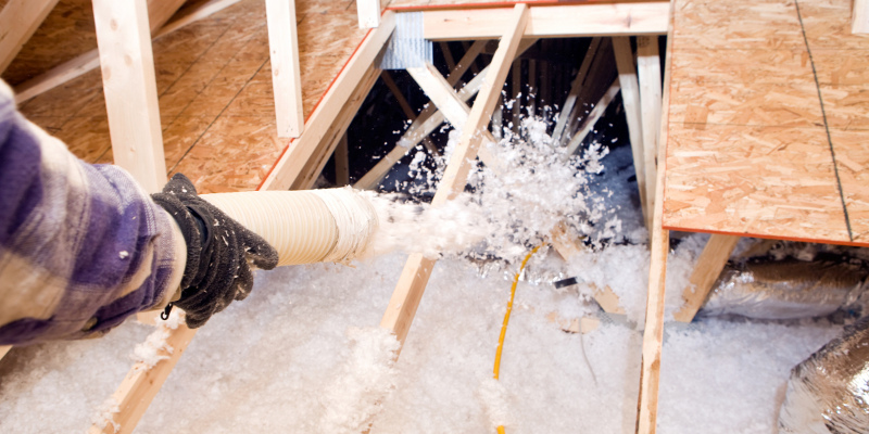 Insulation contractor hands with gloves doing it's job