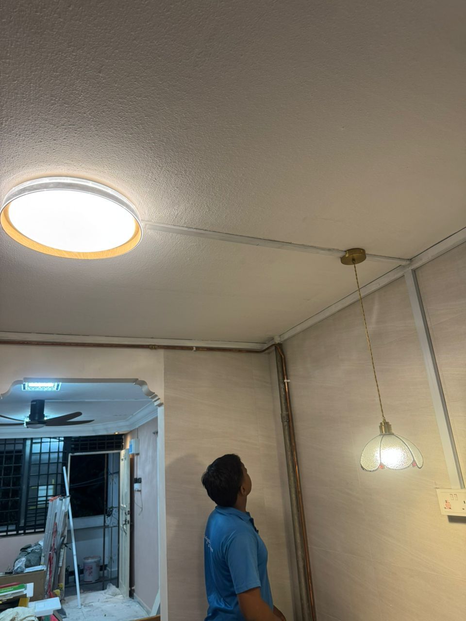 Lito Electrical technician completing residential lighting installation in Singapore