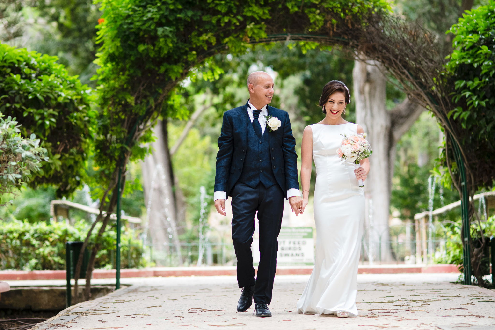 bride and groom walking in the gardens