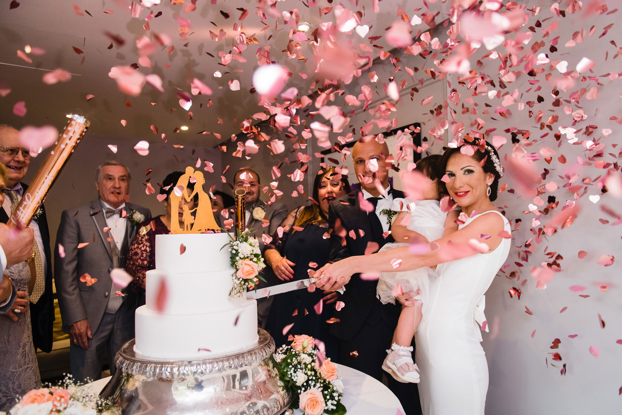 bride and groom cutting wedding cake 