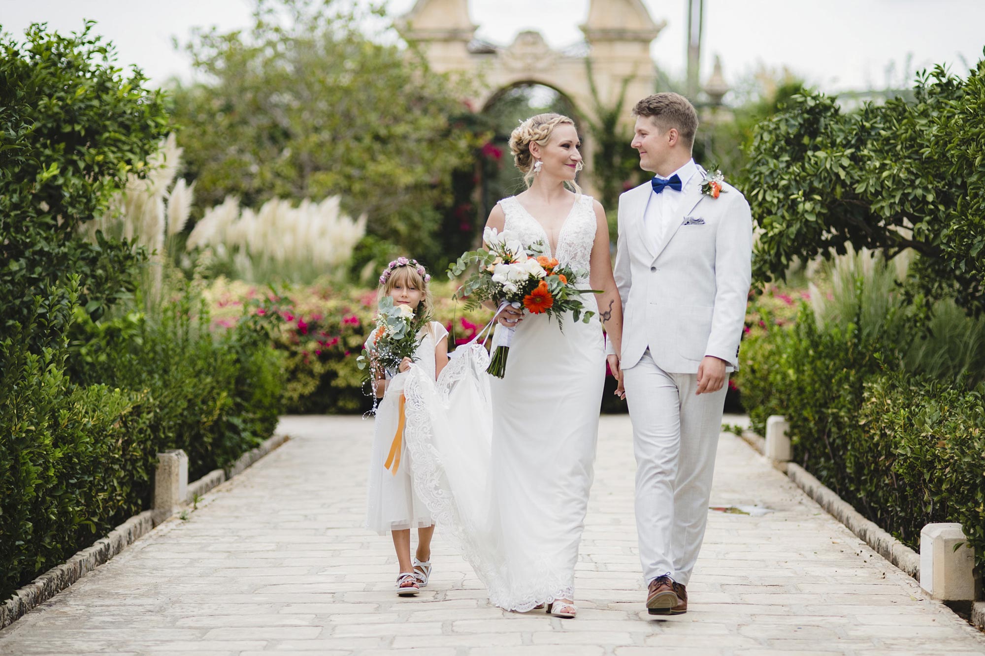 Newlyweds walking outside Palazzo Parisio gardens in Malta