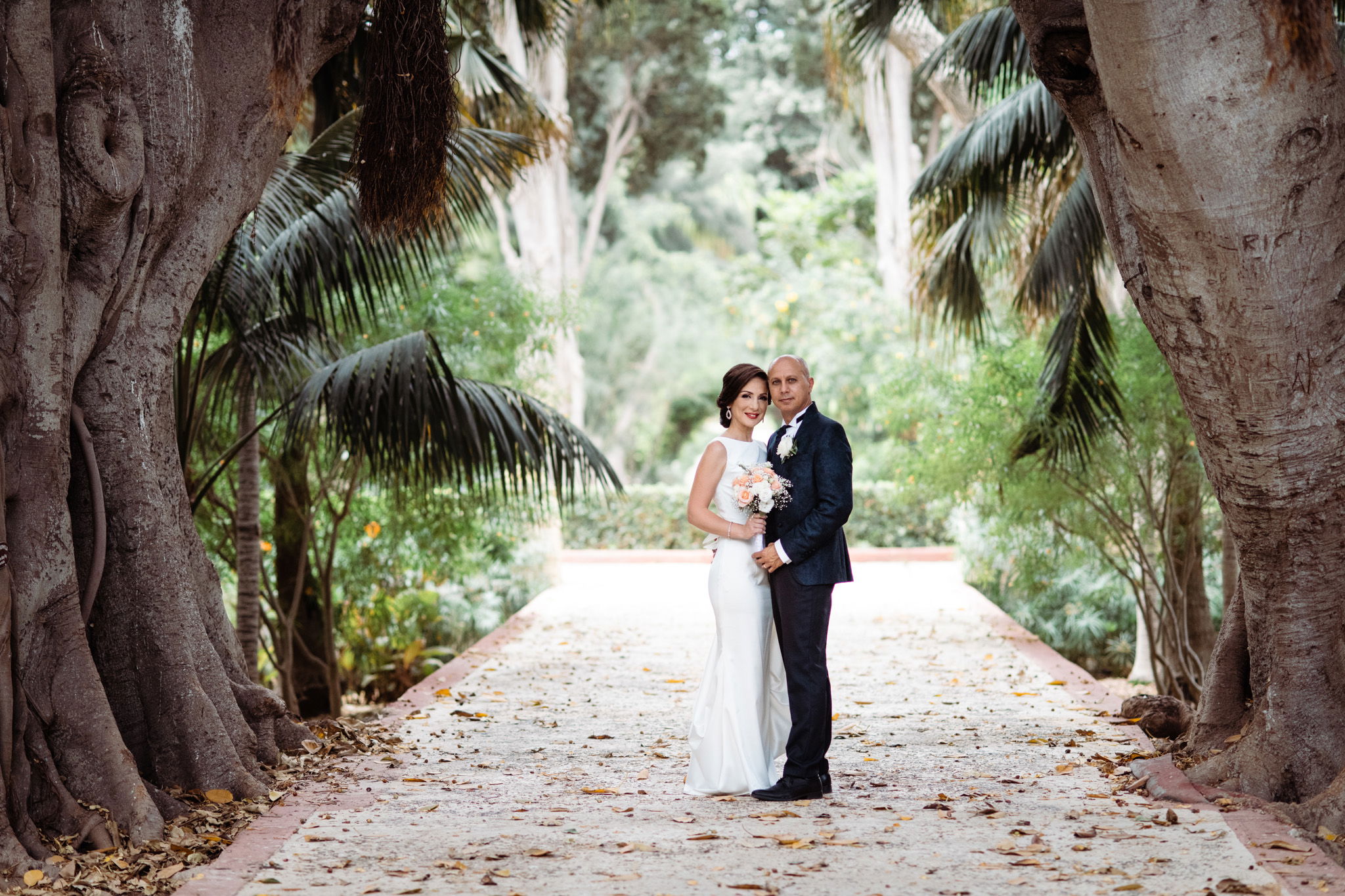 Bride and groom posing at San Anton Gardens