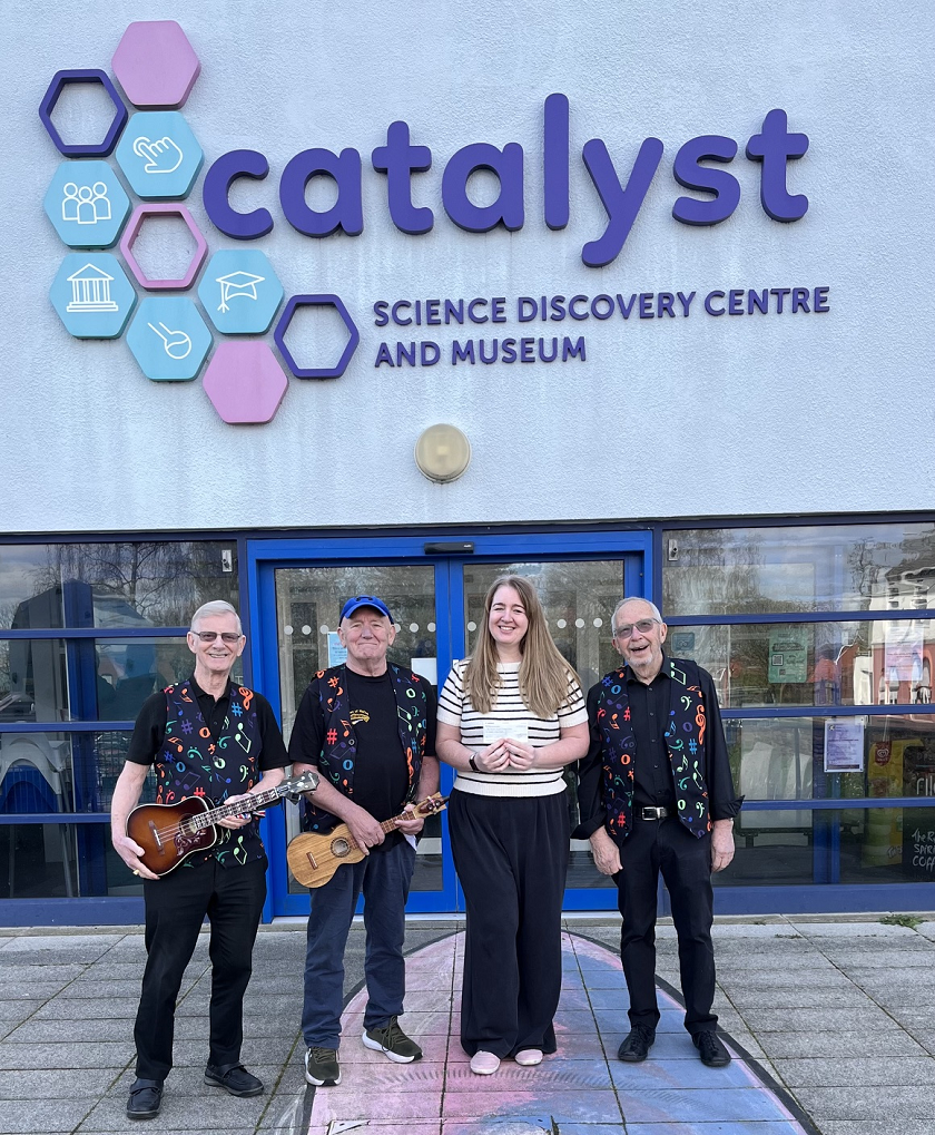 The D'Ukes of Halton Ukulele Band Officers presenting a £250 cheque to the Catalyst Science Discovery Centre