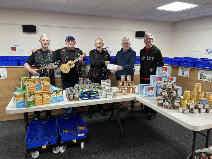 The D'Ukes of Halton Ukulele Band Officers donating £250 worth of food products to Widnes Food Bank