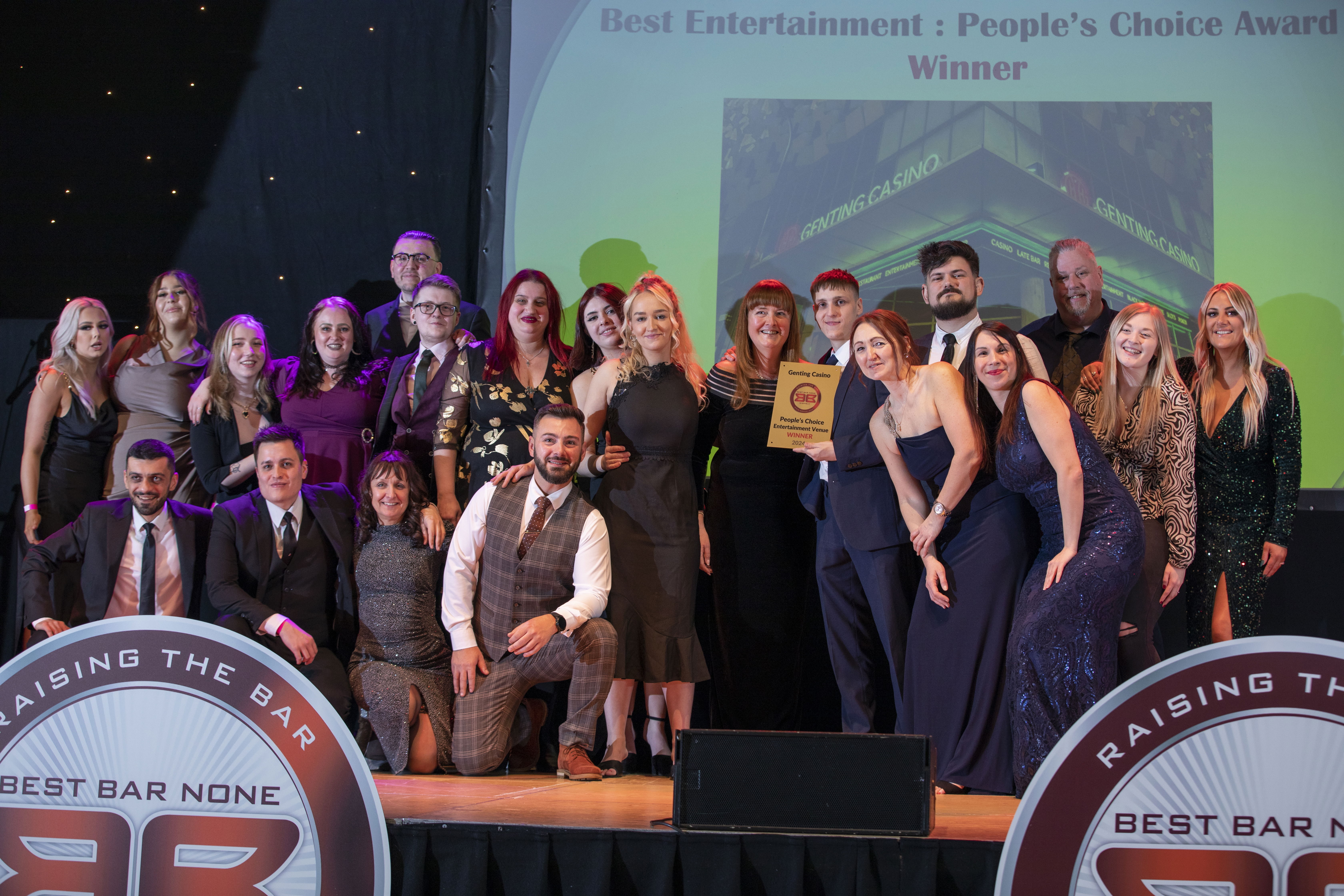 A large group of people on stage receiving an award from the Best Bar None scheme