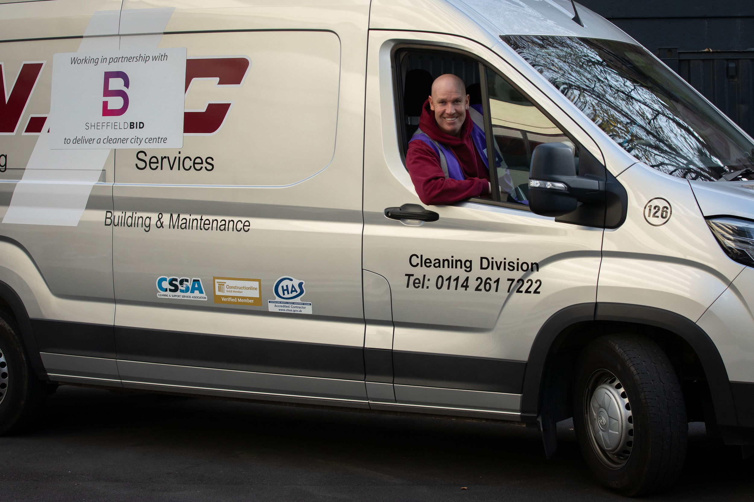 A branded NRC vehicle with a member of staff in the driving seat