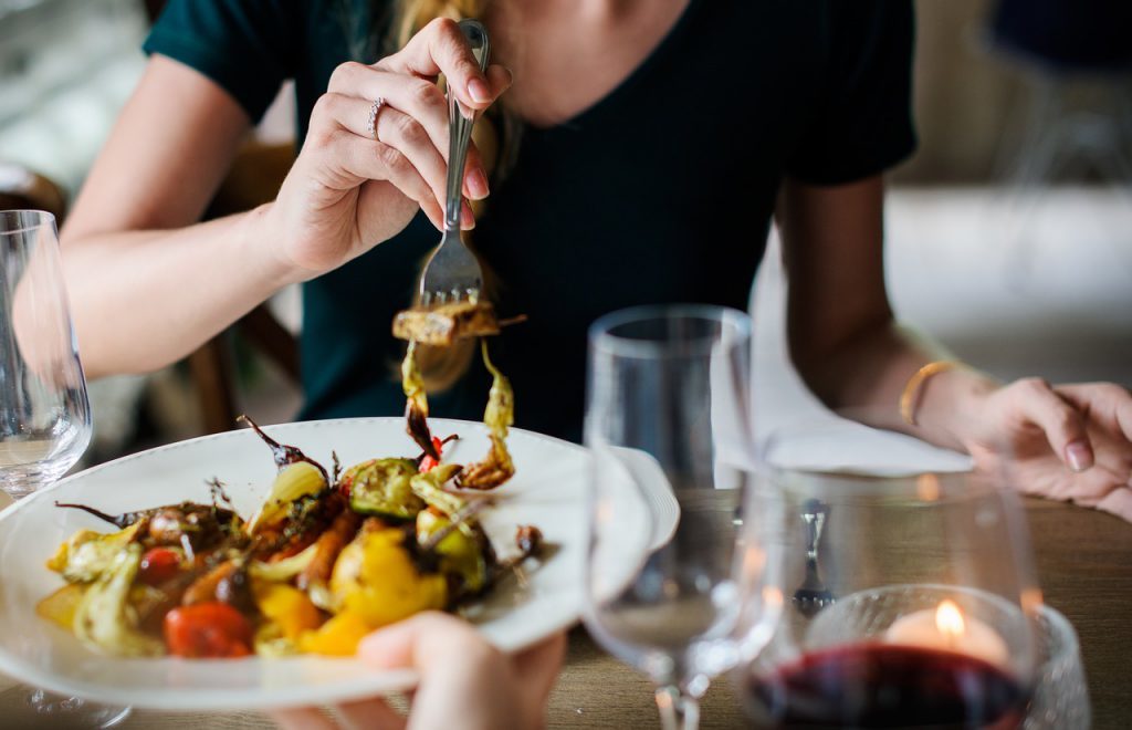 Woman eating stuffed peppers