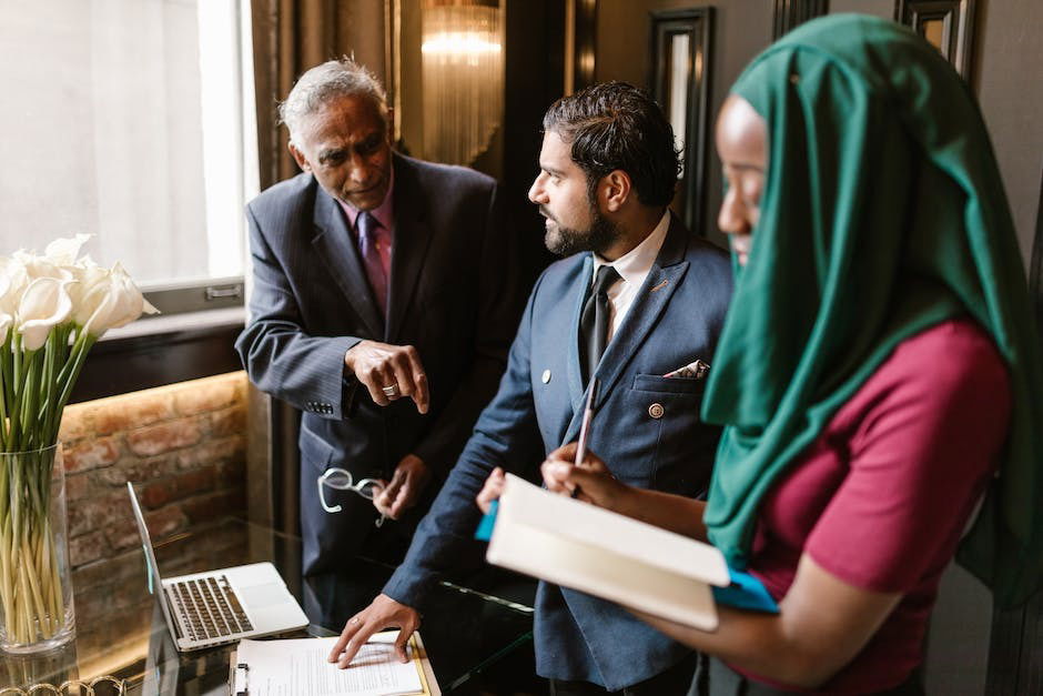 A group of diverse people discussing investments and financial charts