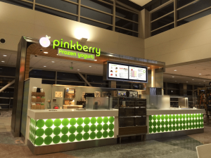 Two digital menu boards at a Pinkberry kiosk.