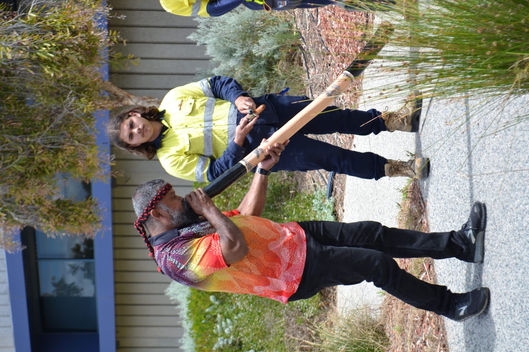 Wilco team member playing the didgeridoo
