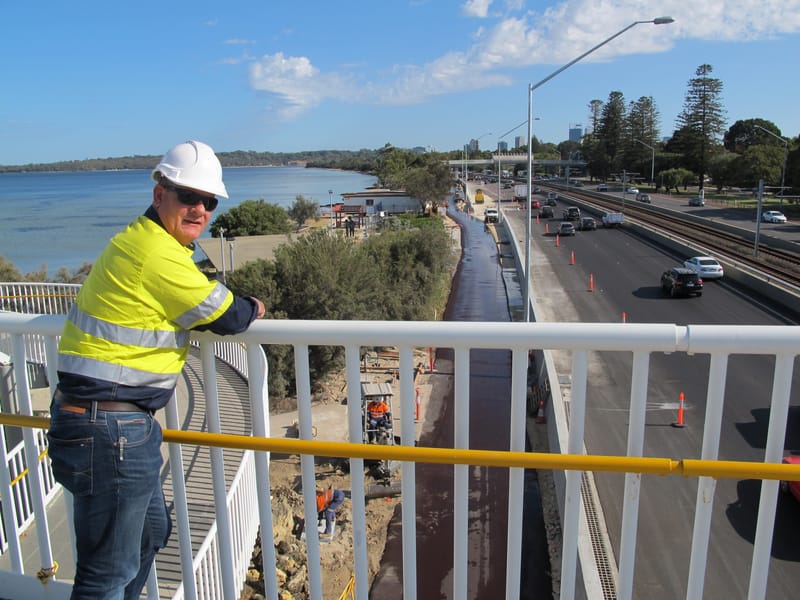Workers on highway overpass