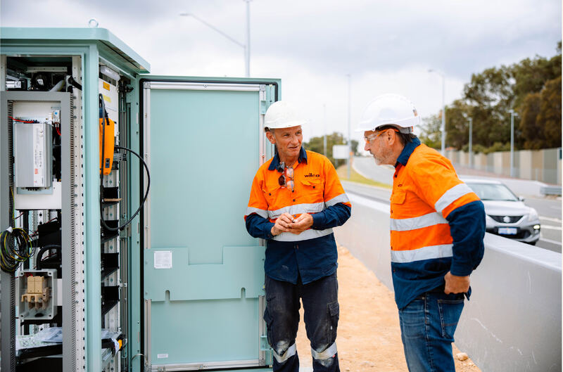 Wilco technicians at an ITS field cabinet on Mitchell Freeway