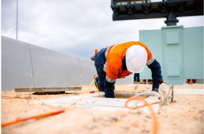 Wilco technician installing cabling beside Mitchell Freeway