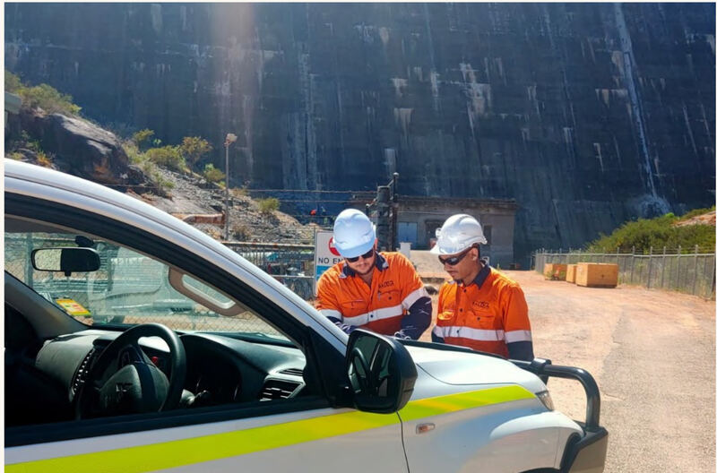 Wilco technicians beside a switchboard at a Water Corporation dam site