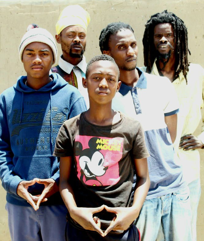 Image of the Group Jah Army Crew Posing for a photo with a trinity sign