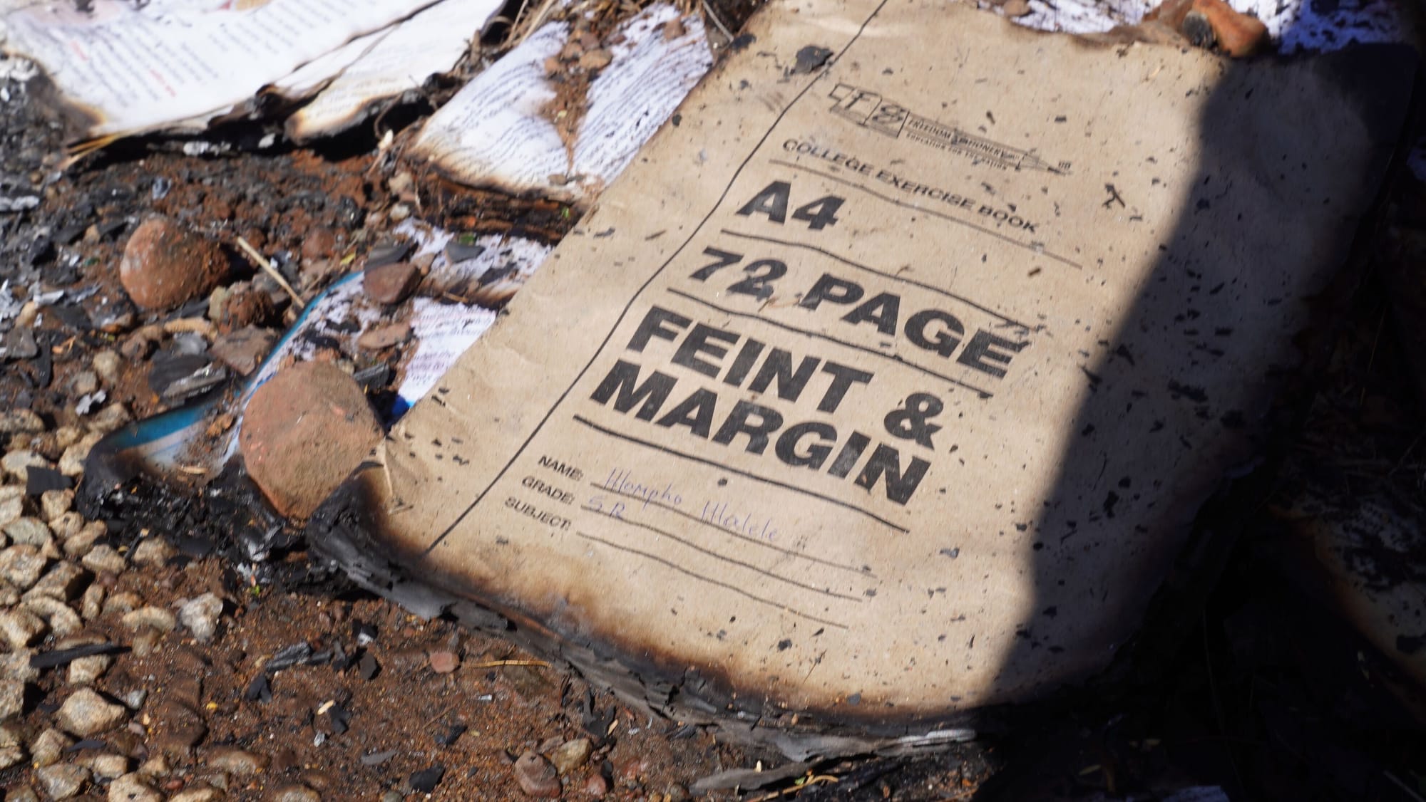 A burnt text book at a scene where 12 learners died and 7 injured in a tragic accident