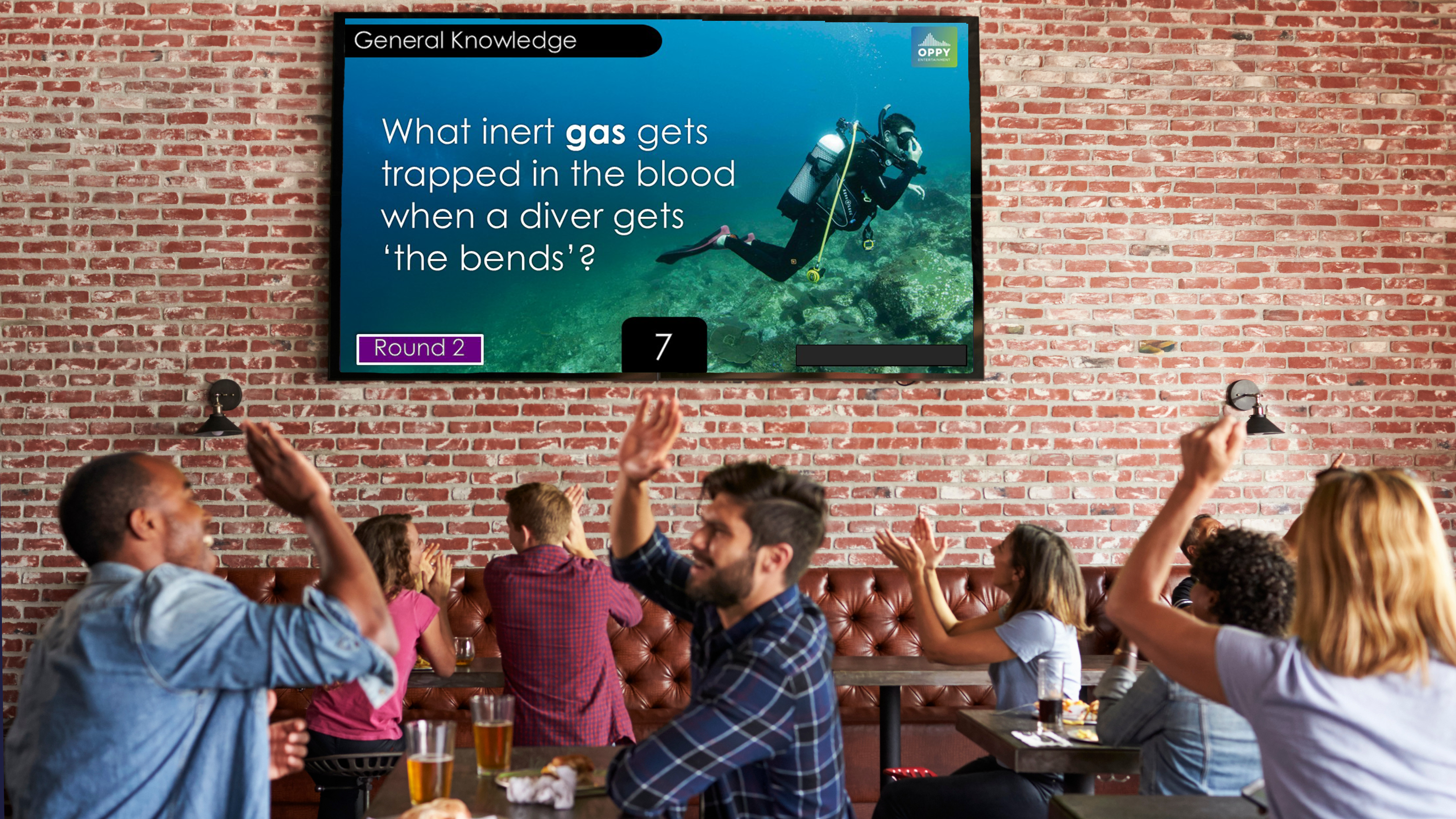 Image of Pub Trivia Australia Big Sceen high resultion image with question for what inert gas is trapped in the blood when a diver experiences the bends with image of scuba diver swiming in beautiful ocean with scuba gear on
