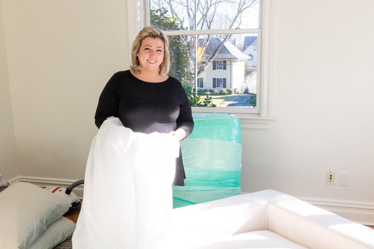 Jen Beato of Stunning Spaces preparing furnishings during a vacant home staging project in Westchester