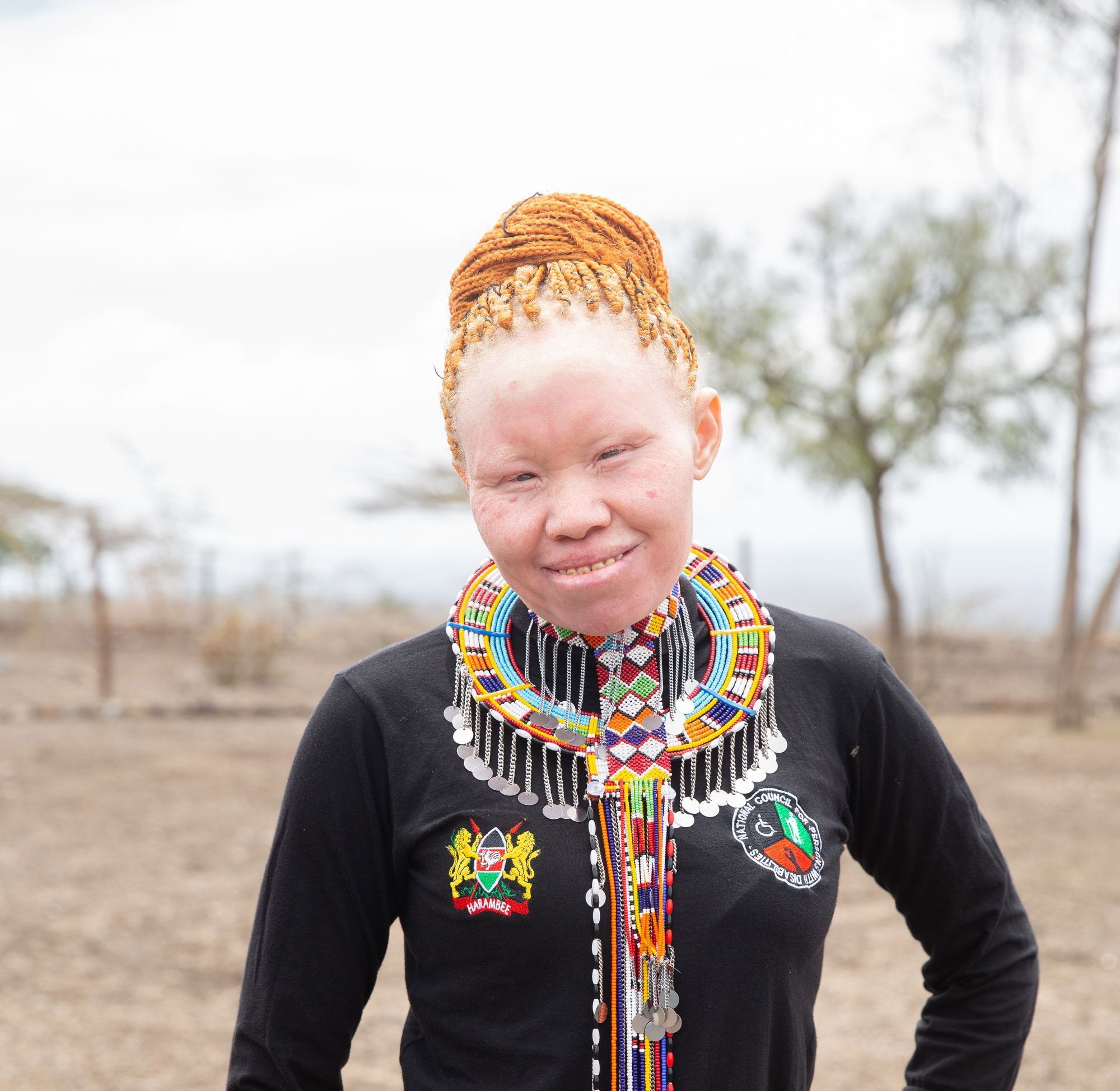 Zipporah attuned in a black pull neck, accessorized by Masai community regalia