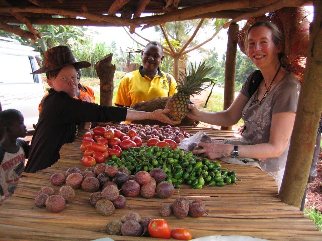 A lady with albinism selling pineapple to one of the team members at Advantage Africa.