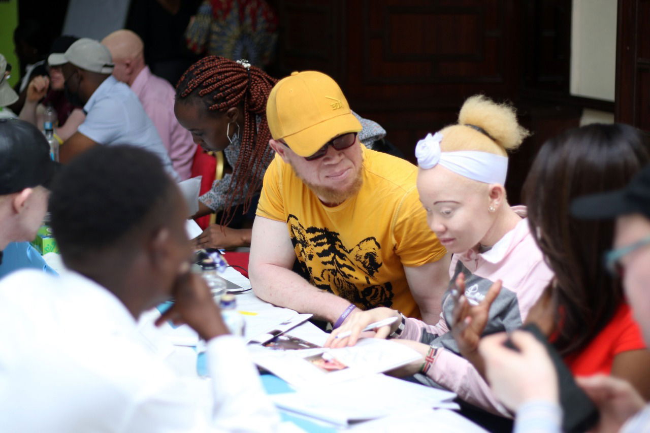 A picture focusing on two persons with albinism during a conference held by Africa Albinism Network.